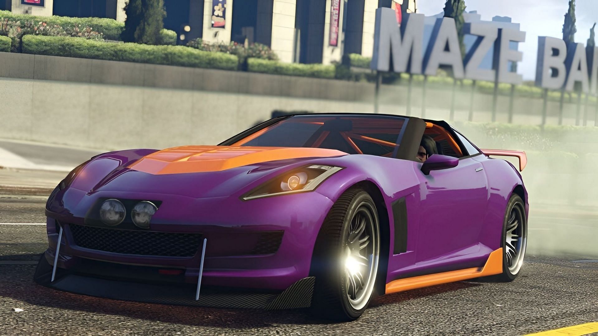 The Coquette sports car speeding past the Maze Bank Arena in Los Santos (Image via Rockstar Games)